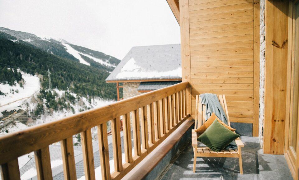 Brown Wooden Chair On A Veranda With View Of A Snowy Mountain